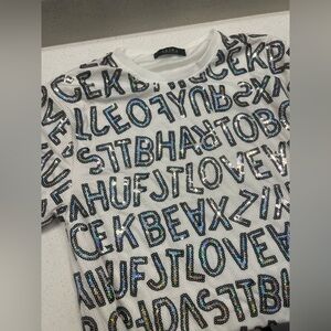 AKIRA Oversized Sequin Graphic Jersey Top Iridescent White